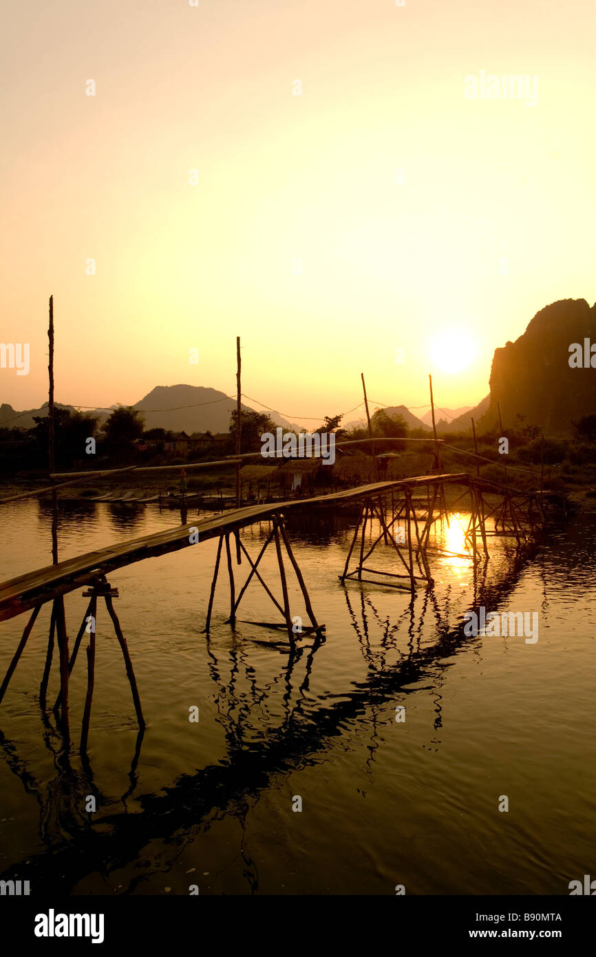 Laos, Vientiane Province, Vang Vieng, Nam Song River, bamboo bridge, limestone hills. Stock Photo