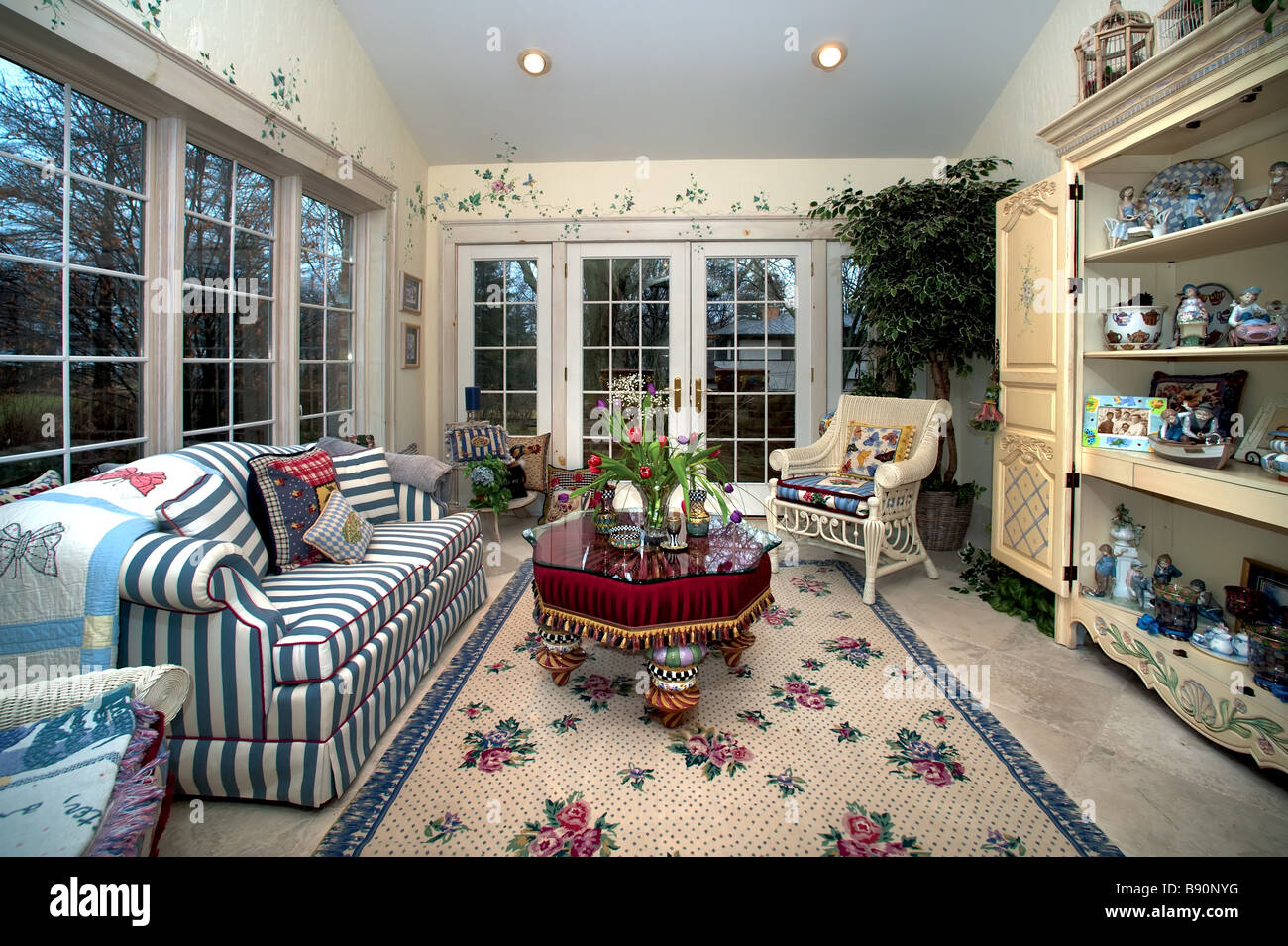 Furnished Sunroom With Large Windows And Glass Doors Stock