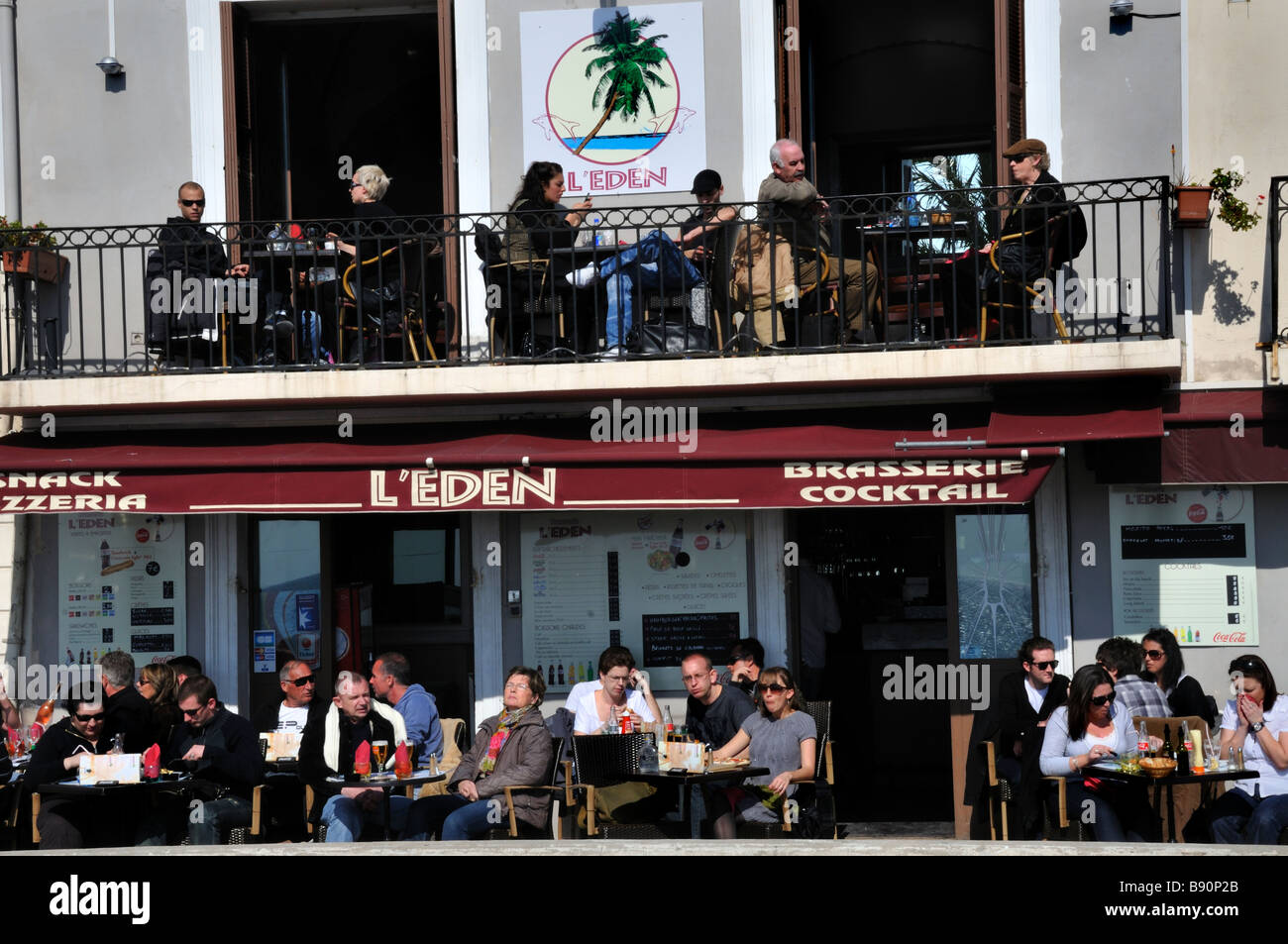 Nice France, Large Crowd People 'French Cafe' 'French Brasserie Restaurant' Sidewalk Crowded terrace Tables, Front 'L'Eden Pizzeria' Stock Photo