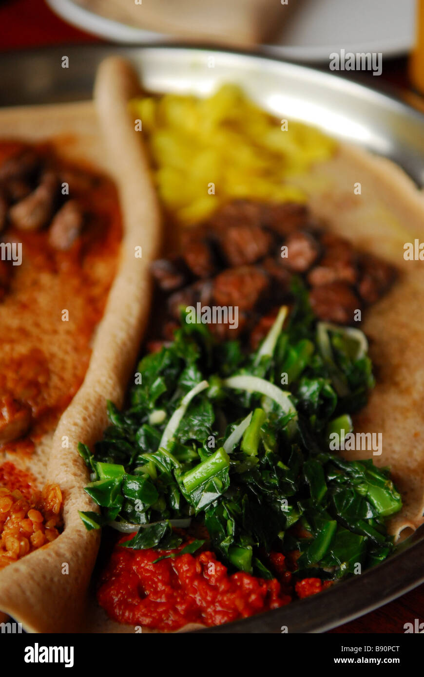 Detail of platter of Ethiopian food served atop injera bread Madjet Ethiopian Restaurant Bar 1102 U Street NW Washington DC Stock Photo