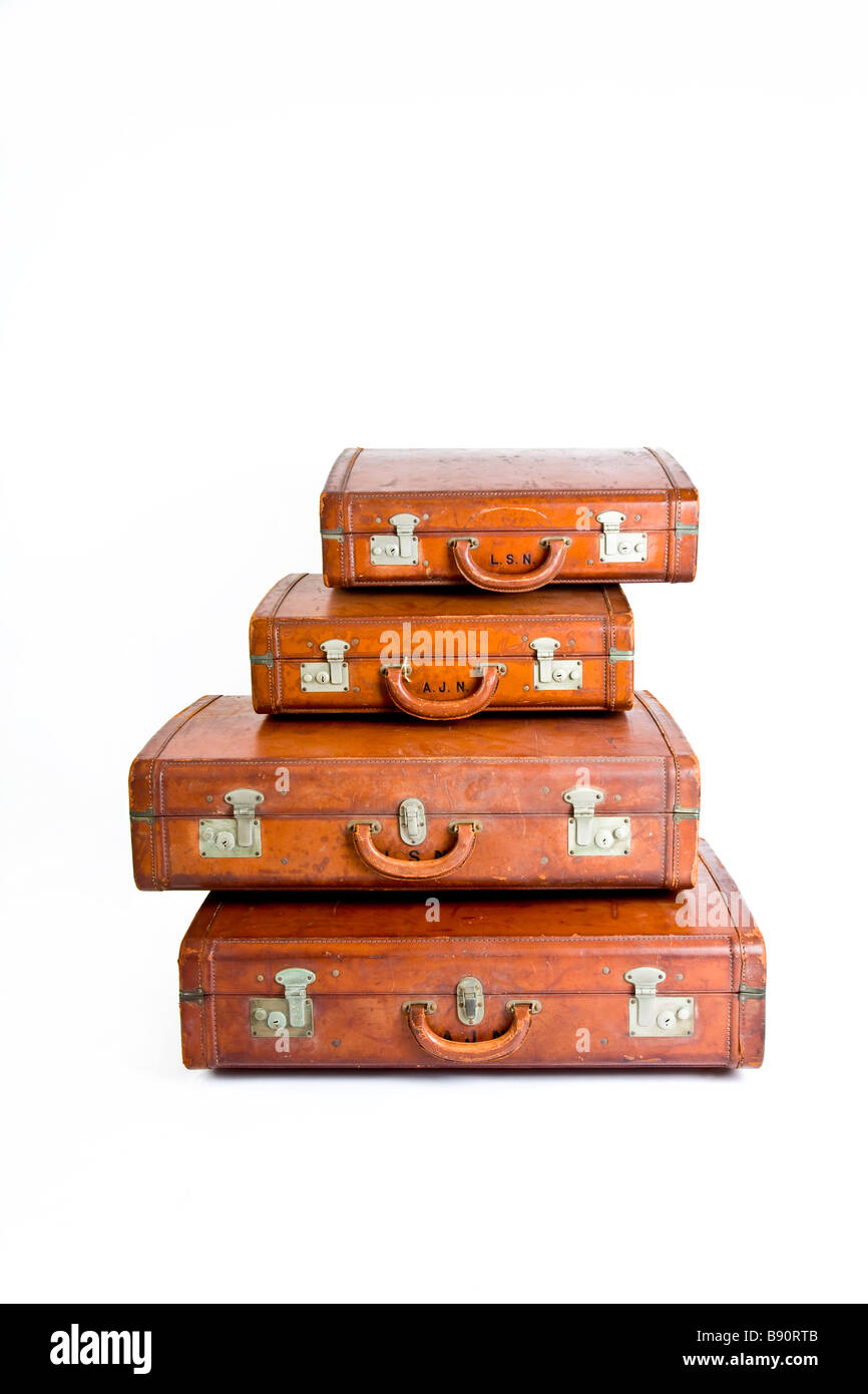 Four traditional leather suitcases on top of one another Stock Photo