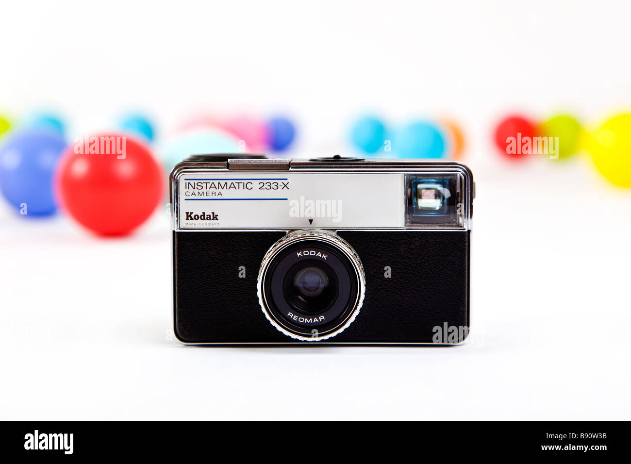 Kodak Instamatic 233x camera with vivid coloured balls behind Stock Photo
