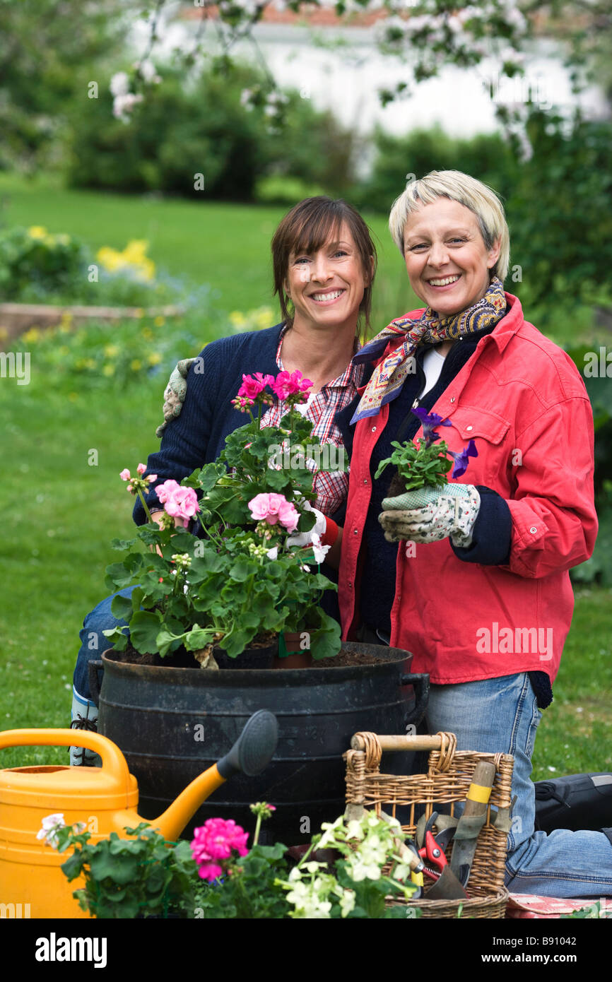 Two women setting flowers in pots Sweden. Stock Photo