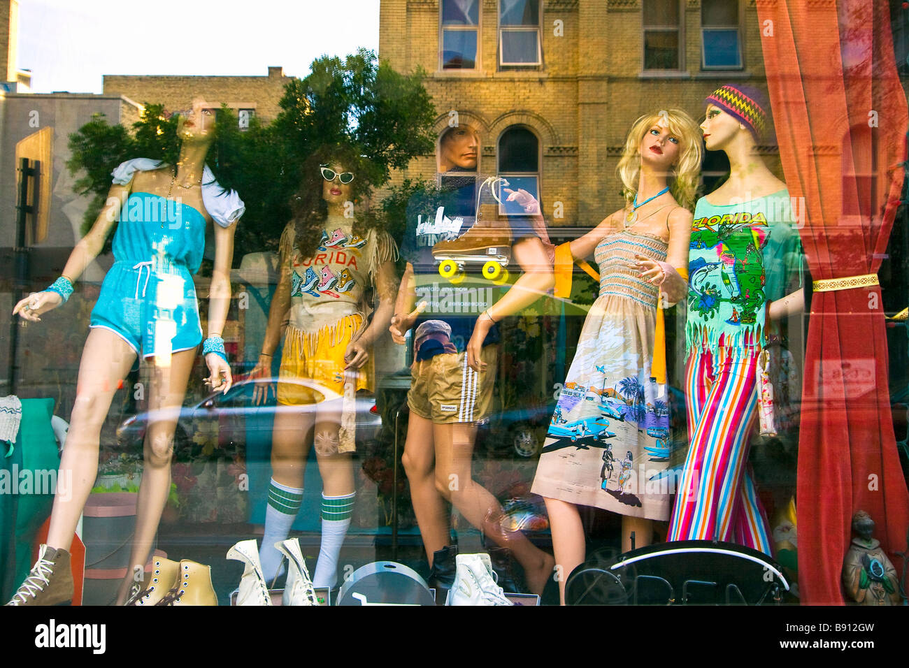 Mannequins and street reflection in a storefront window. Exchange