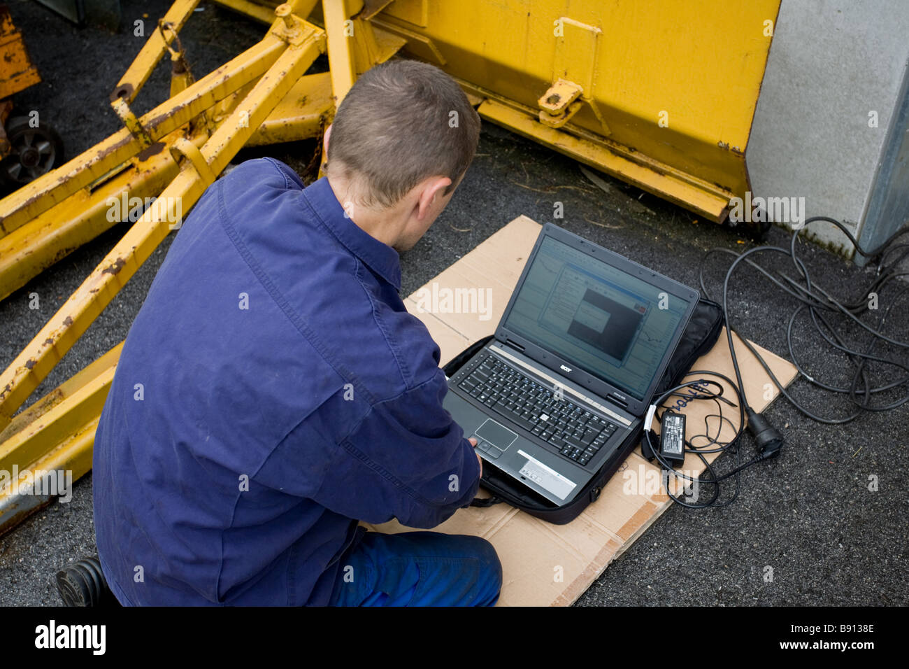 Mechanic with his laptop Stock Photo