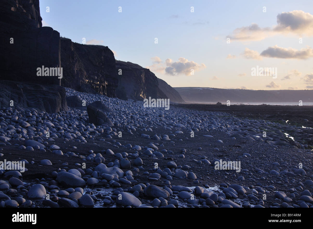 Cliffs and pebbles at dusk Stock Photo