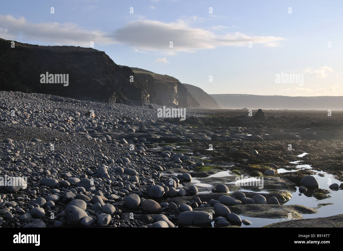 Bright beach with cliffs at low tide Stock Photo