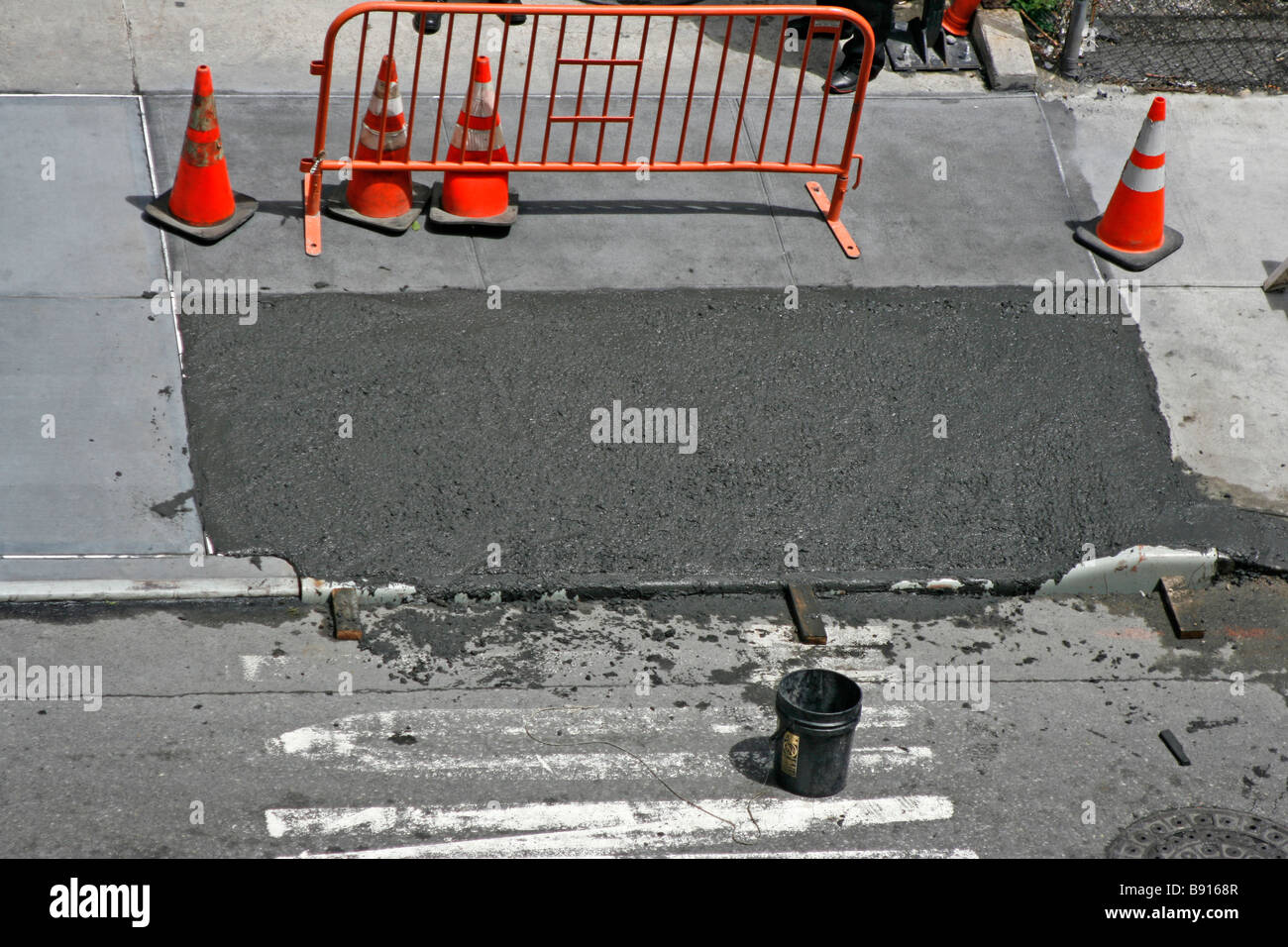 Wet cement drying on sidewalk. Stock Photo