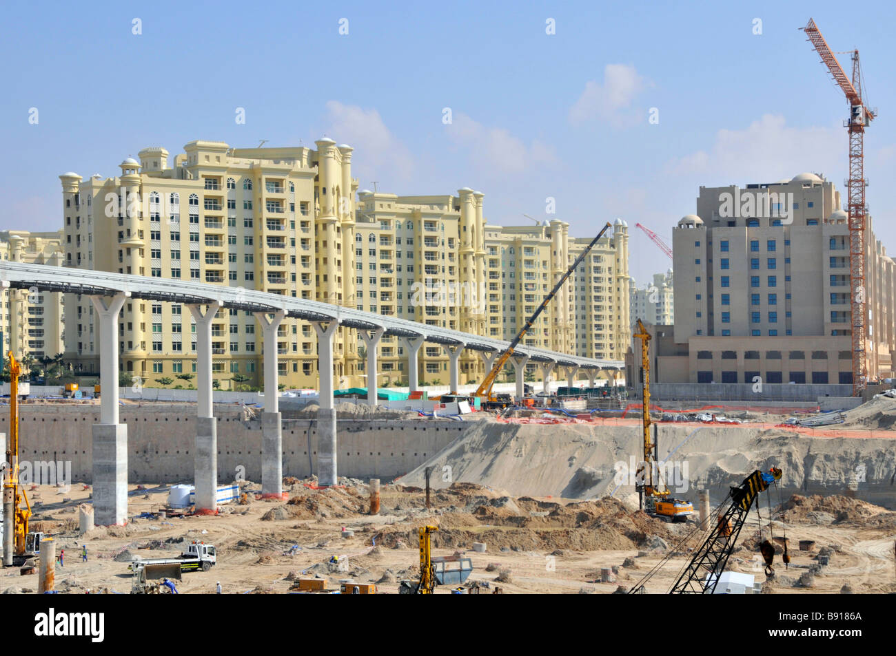 Dubai artificial Palm Island development site below and around overhead monorail viaduct which will link to new metro service Stock Photo