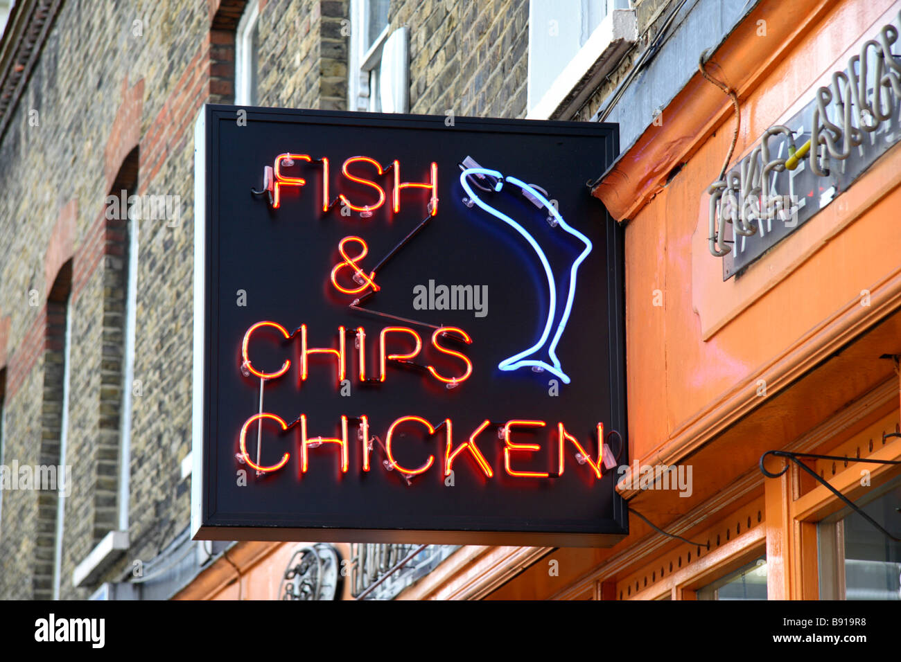 A fish & chips neon sign above a shop in Victoria, London. Mar 2009 Stock Photo