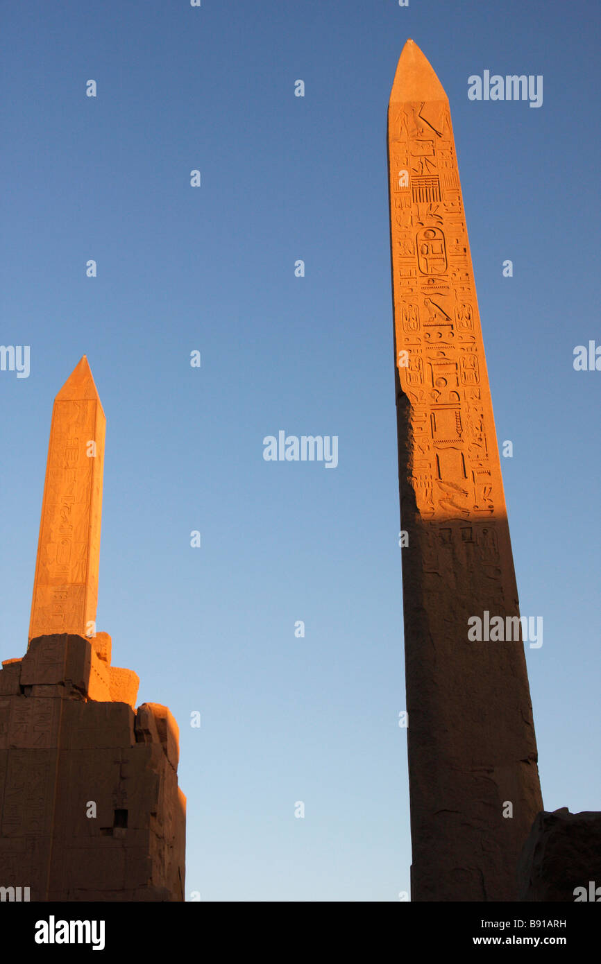 Two Obelisks of Queen Hatshepsut and Pharaoh Tuthmosis I against blue sky at sunset, Karnak Temple, Luxor, Egypt Stock Photo