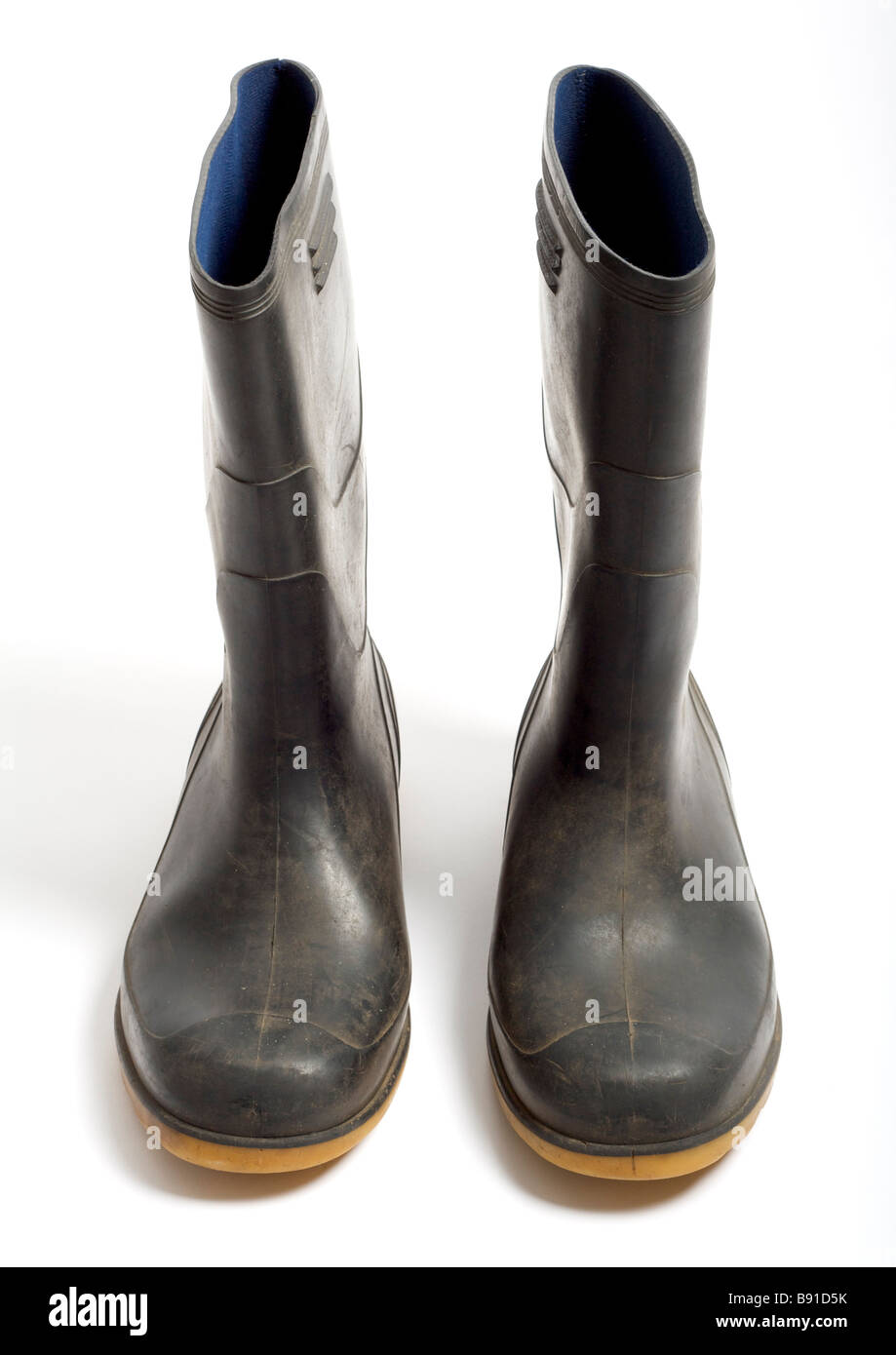 Old pair of wellington boots on white background Stock Photo