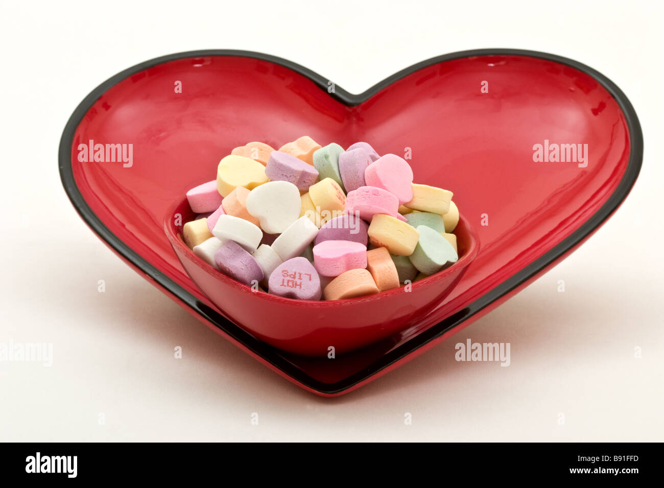 Small candy dish filled with heart shaped candy inside a larger heart