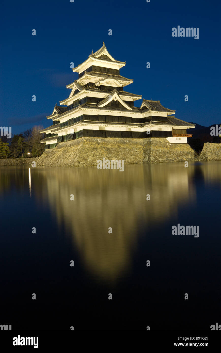 Matsumoto castle by night against a blue sky. Stock Photo