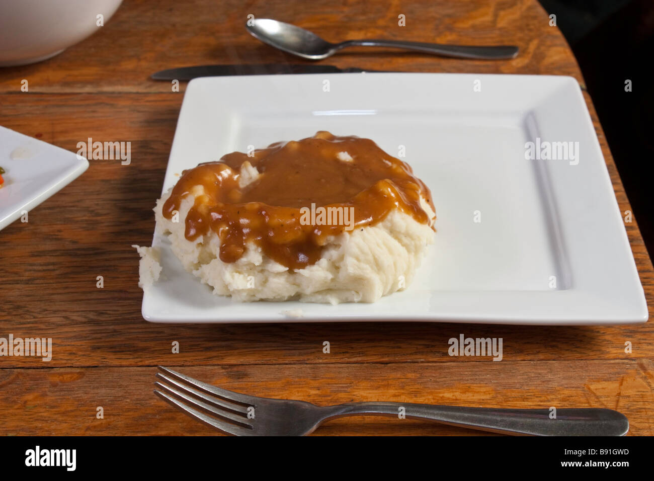 Mashed potatoes and gravy on a white plate Stock Photo