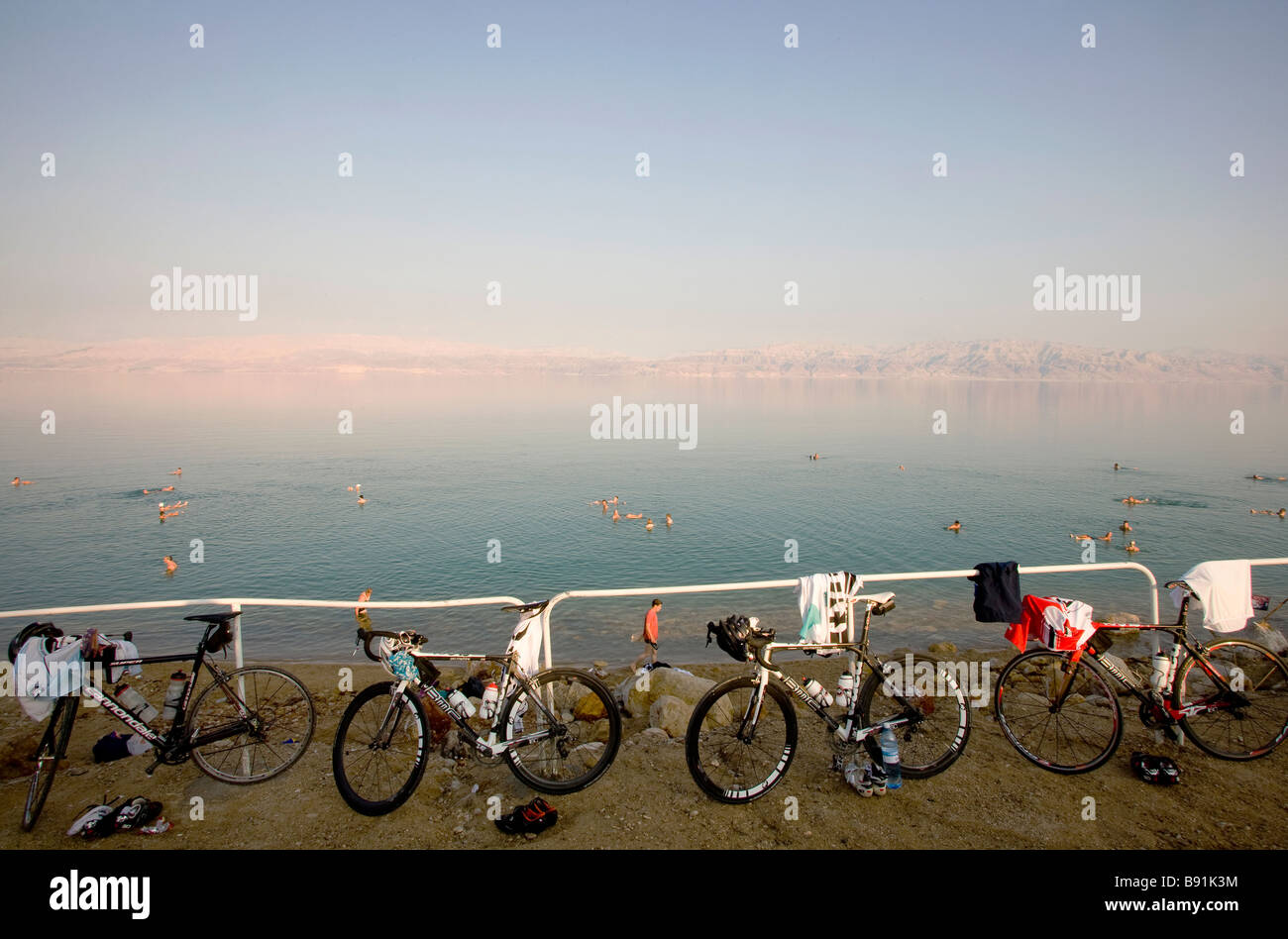 Tourists floating in Dead Sea and bicycles on shore, Israel, Middle East Stock Photo