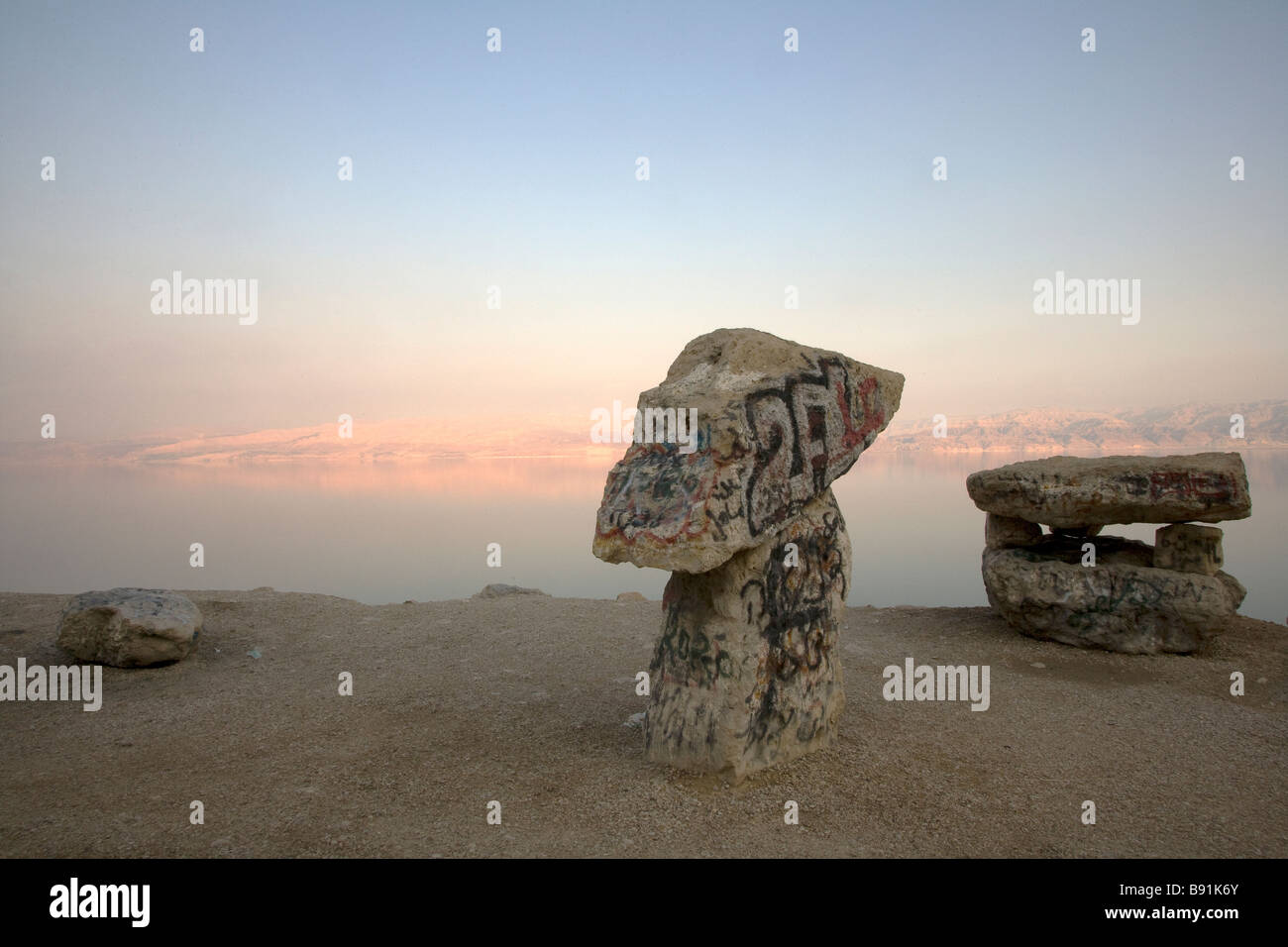 Rock balanced on top of another on Dead Sea shore at sunset, Israel, Middle East Stock Photo