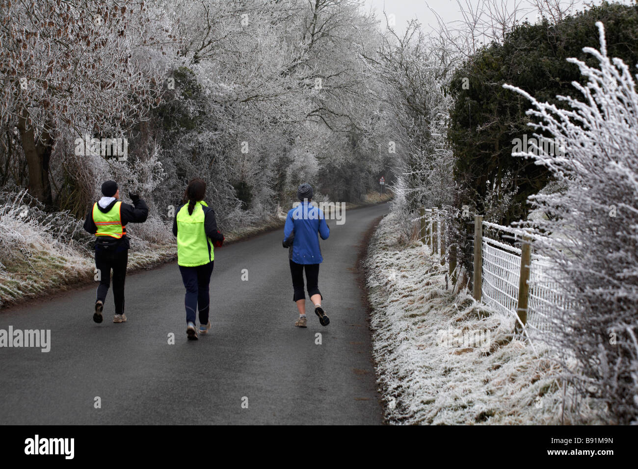 Jogging through the Dorset countryside covered with hoar frost hoarfrost at Dorset, UK in January Stock Photo