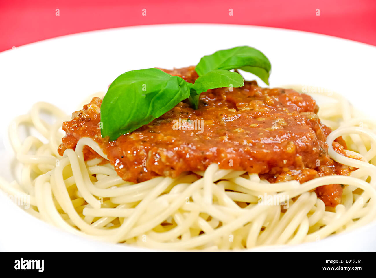 Spaghetti Bolognaise With Fresh Basil Stock Photo Alamy