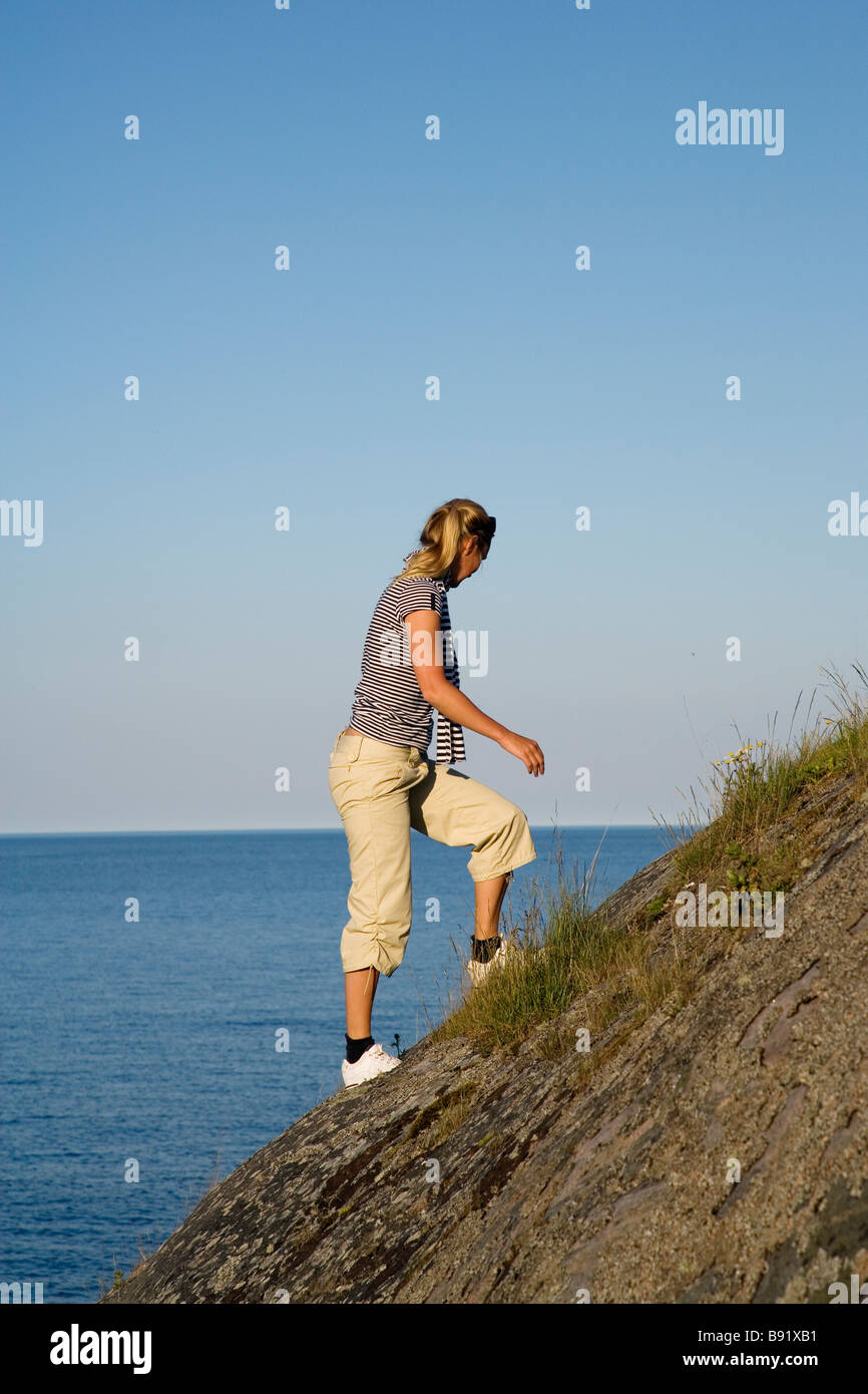 A woman walking uphill Ostergotland Sweden Stock Photo - Alamy