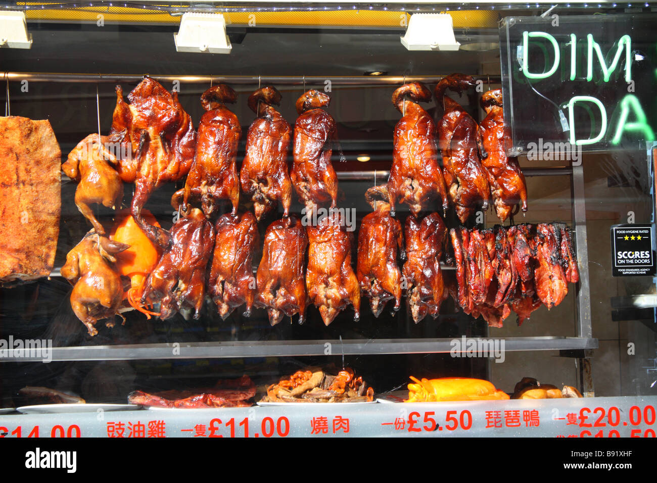 Peking Ducks in the window of a restaurant in China town London Stock