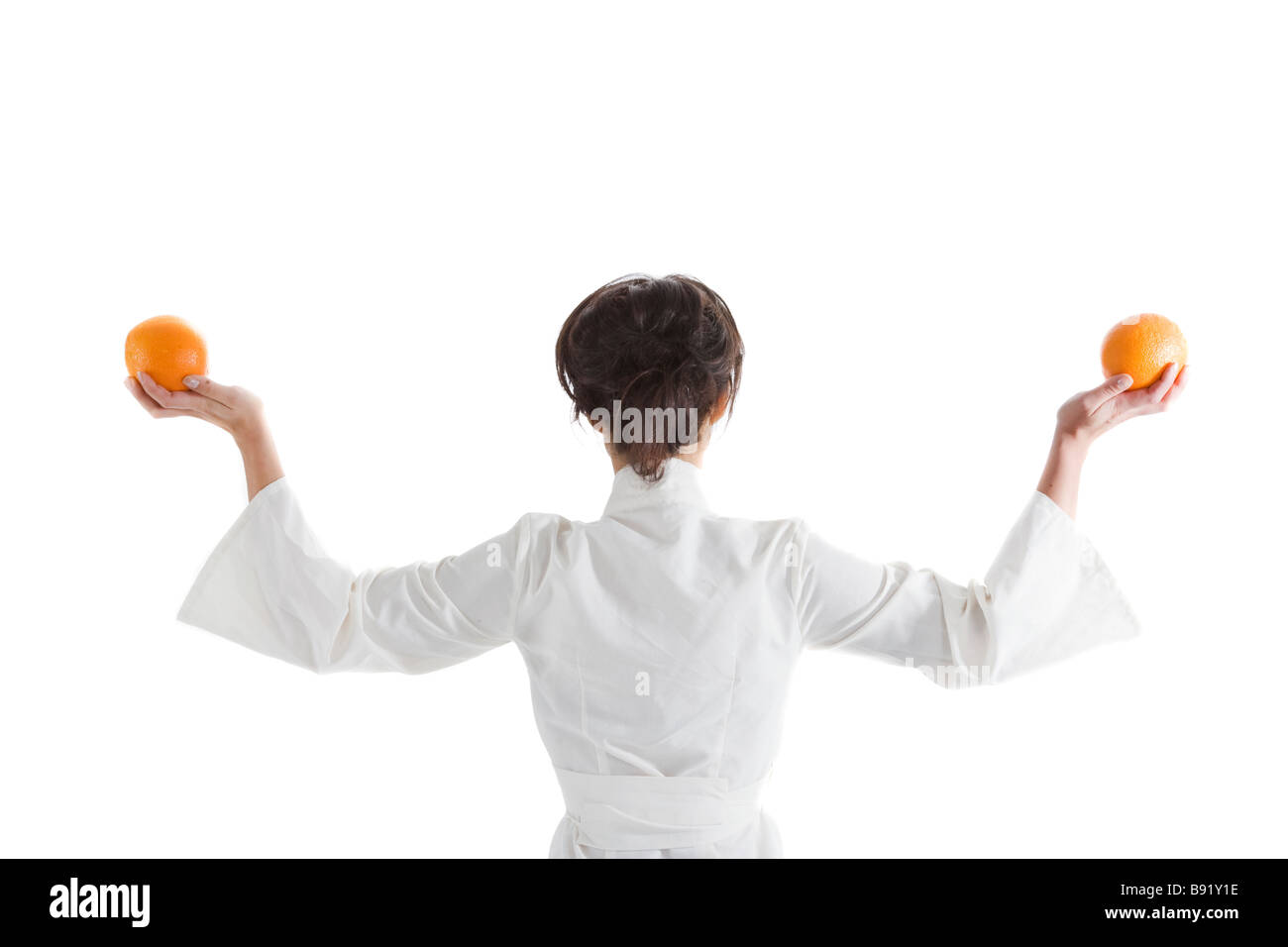 Woman holding an orange in each hand Sweden Stock Photo - Alamy