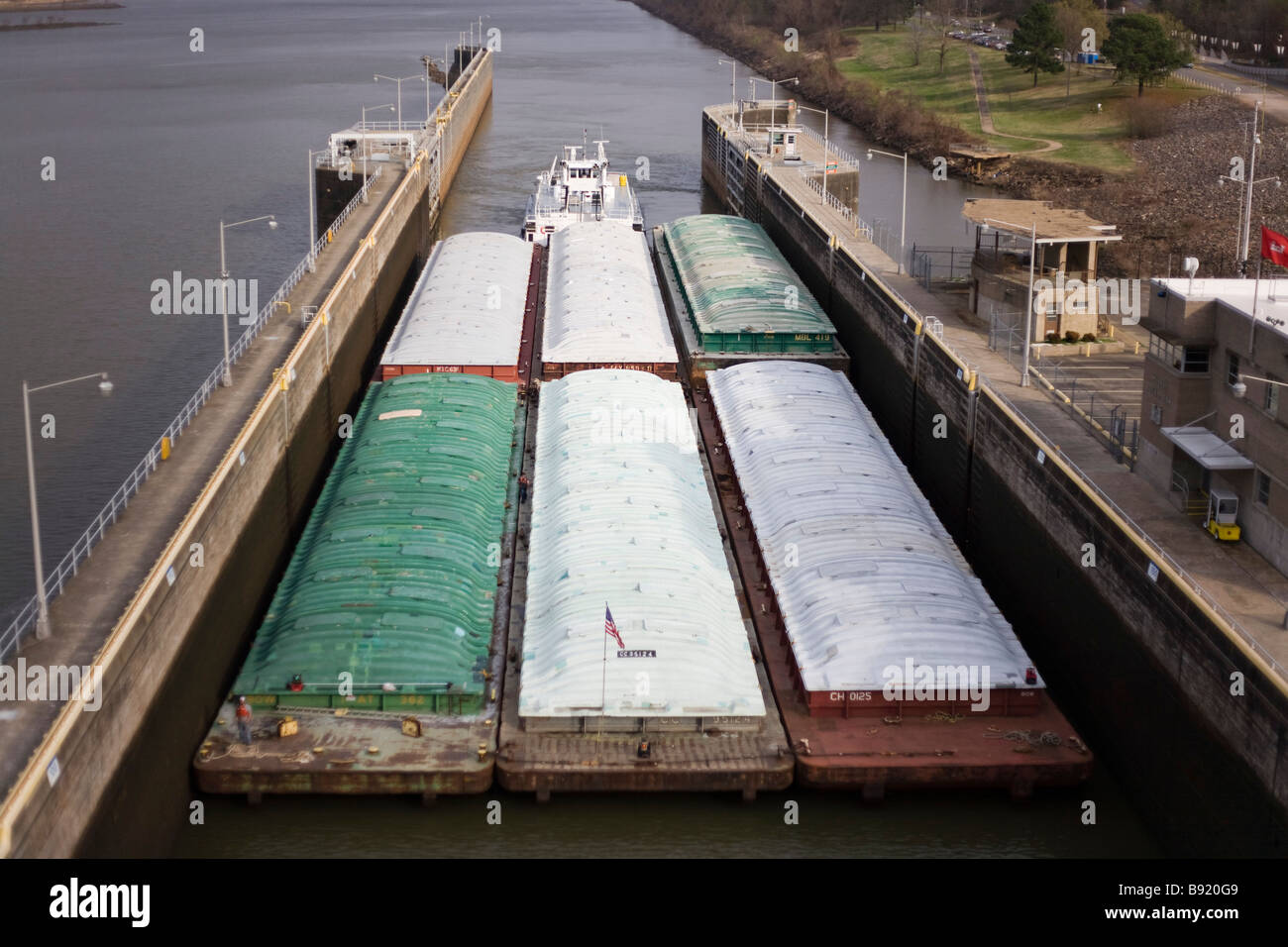 Large cargo barge passing through a lock and dam system along the Arkansas River near Little Rock. Stock Photo