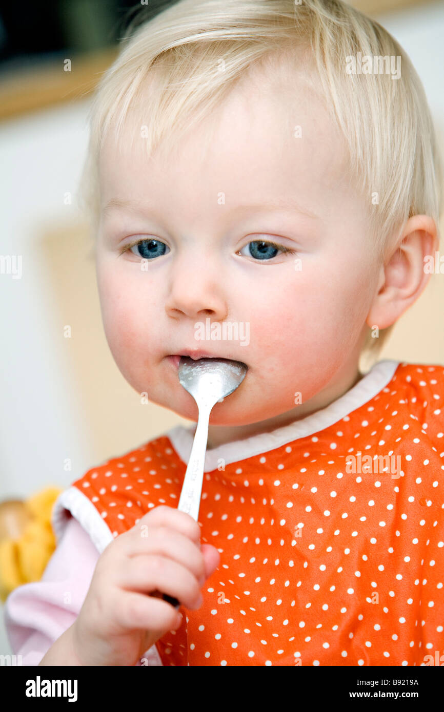 Blond baby girl eating Sweden Stock Photo - Alamy