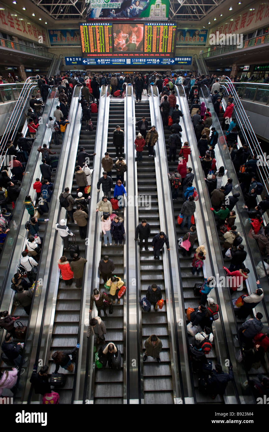 Escalators carrying passengers to trains inside Beijing West Railway Station China Stock Photo