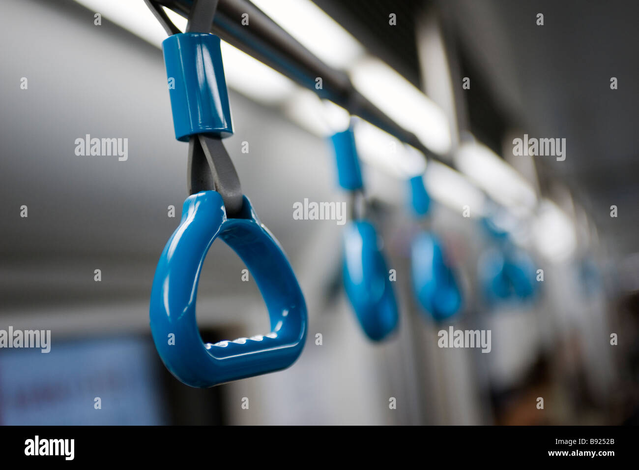 Detail of hand straps in new carriage on subway line in Beijing Stock Photo