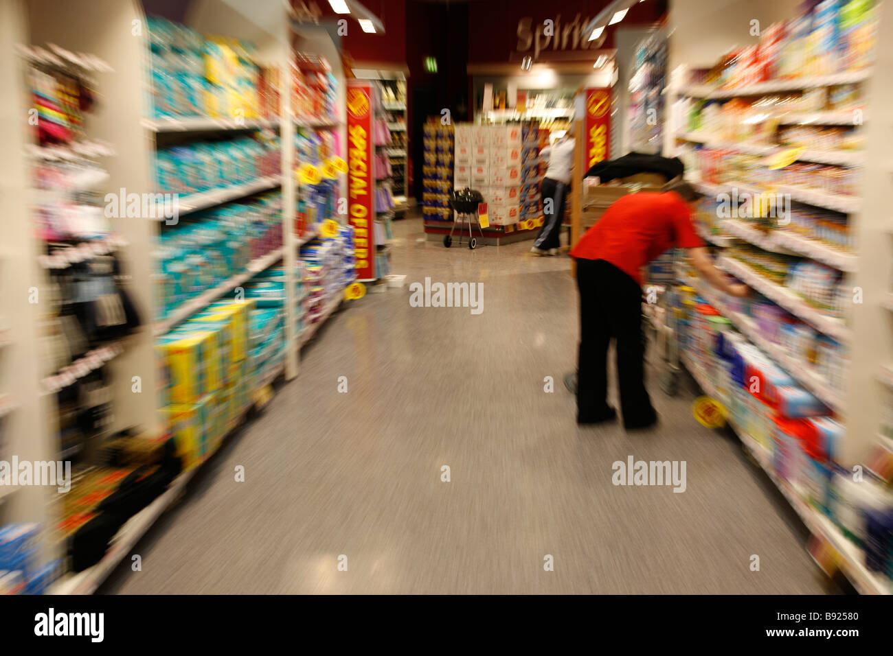 a shop assistent restock a shelf in a supermarket Stock Photo Alamy