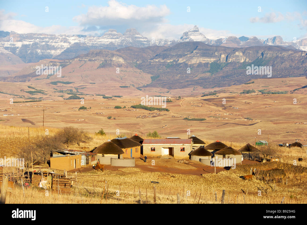 Small rural village in front of the snow covered Drakensberg Mountains
