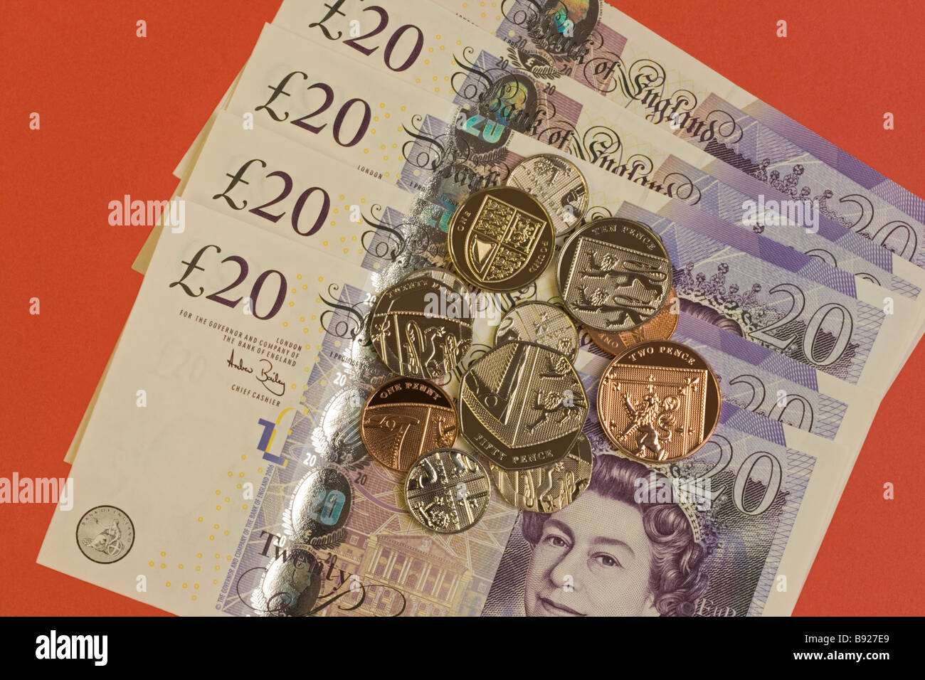 Twenty pound notes with sterling coins Stock Photo
