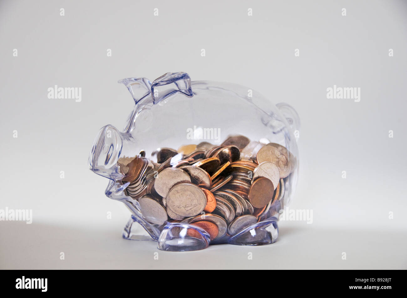 Clear glass piggy Bank on white background Stock Photo - Alamy