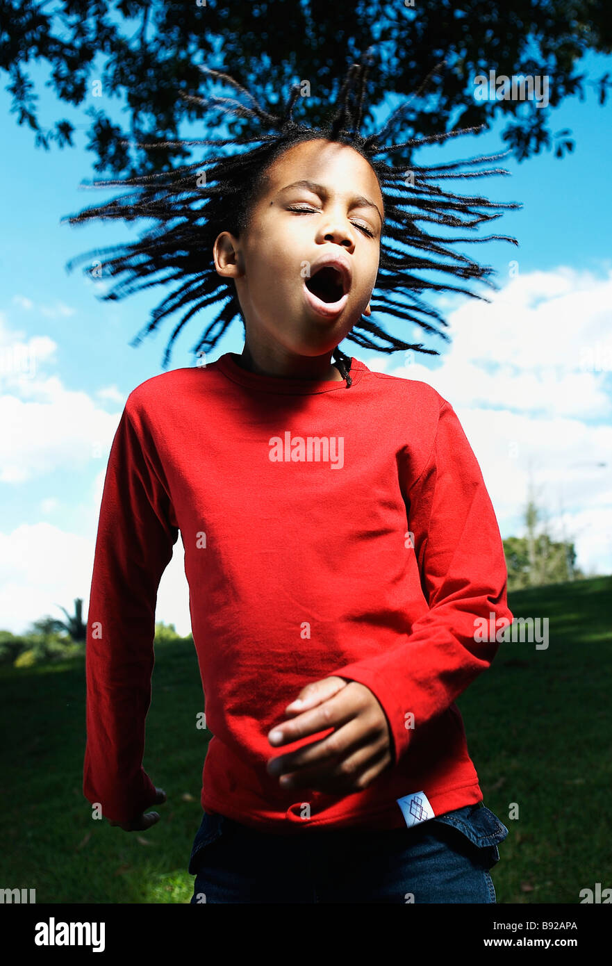 Boy jumping with eyes closed mouth open and hair flying Zoolake Park