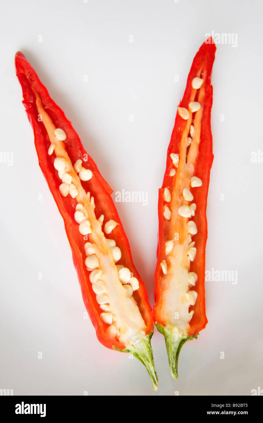 Red chilli pepper cut in two showing the internal membrane and seeds Stock Photo