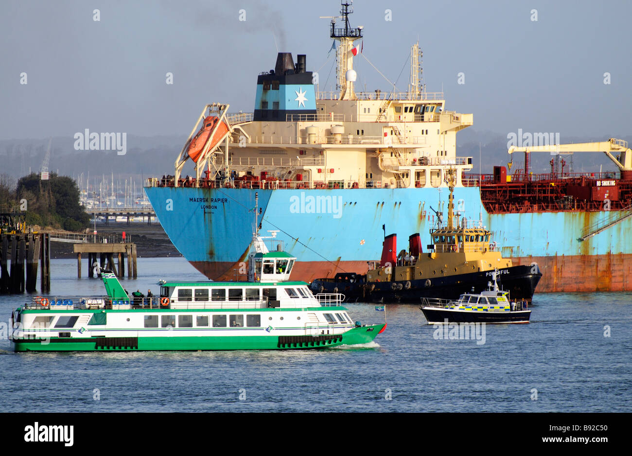 Maersk Rapier product oil tanker ship departing a fuel jetty in the busy Portsmouth Harbour England UK Gosport ferry passing Stock Photo
