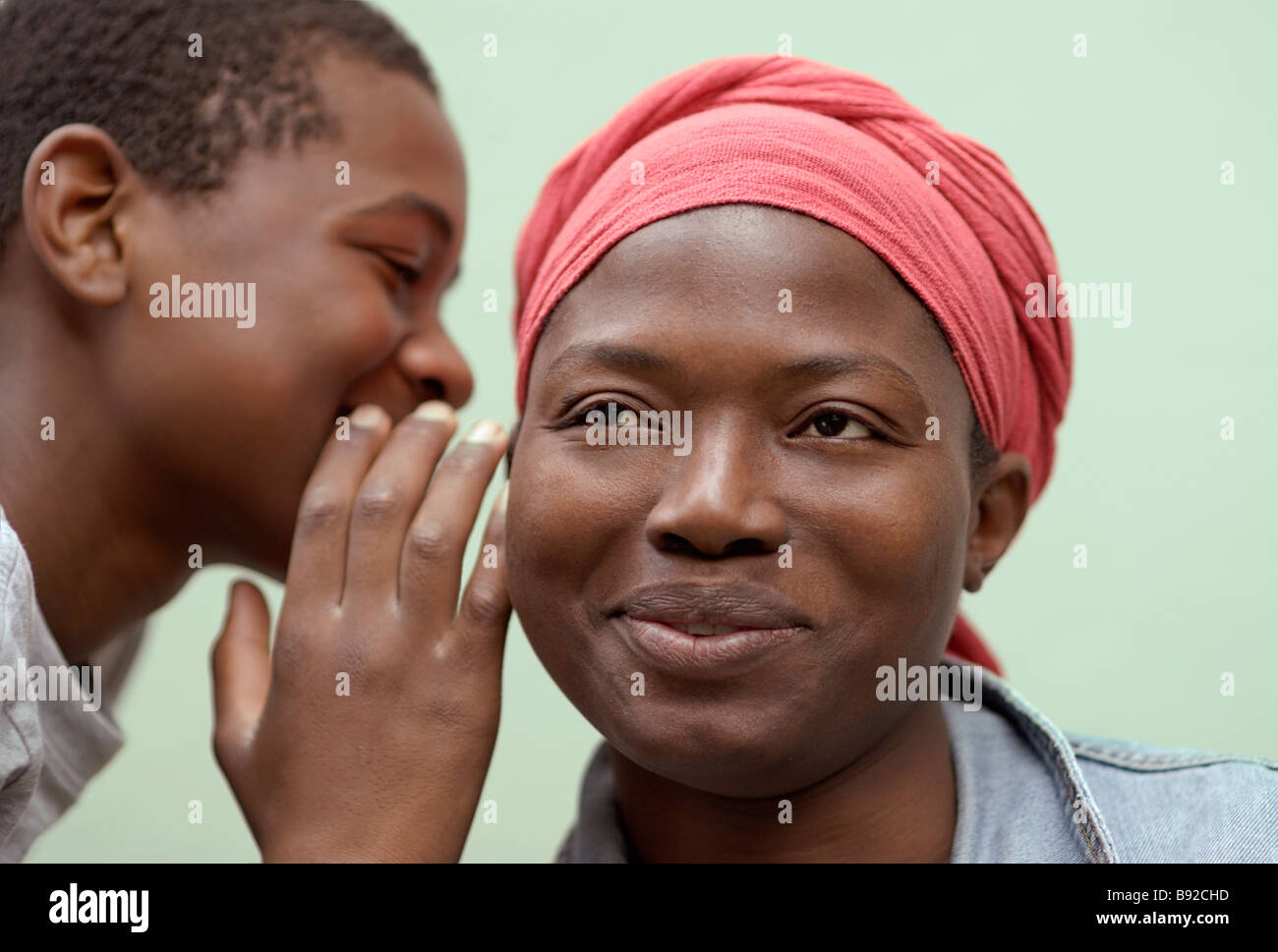 Young man whispering in smiling woman s ear Cape Town Western Cape Province South Africa Stock Photo