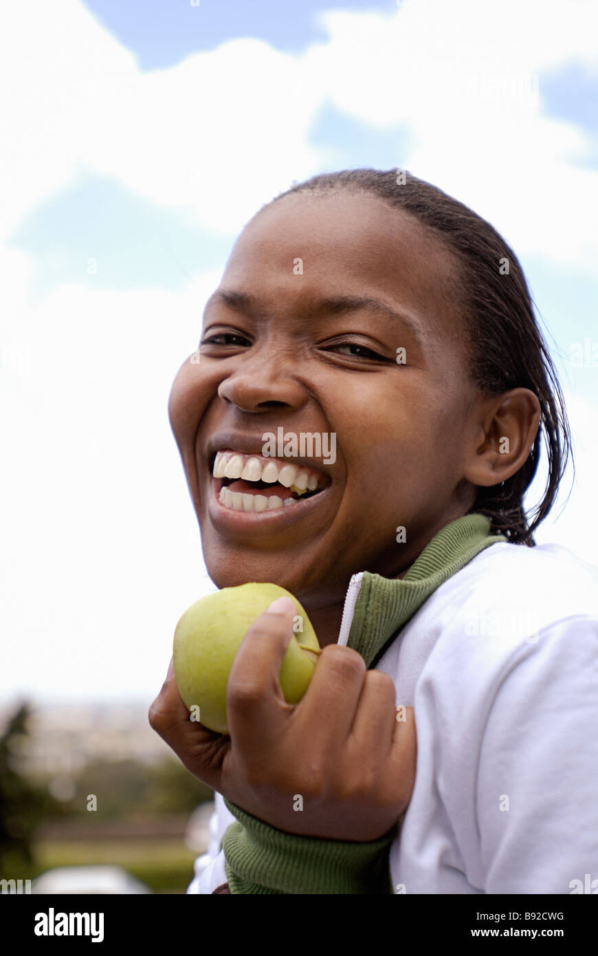 Young girl with apple smiling Cape Town Western Cape Province South Africa Stock Photo
