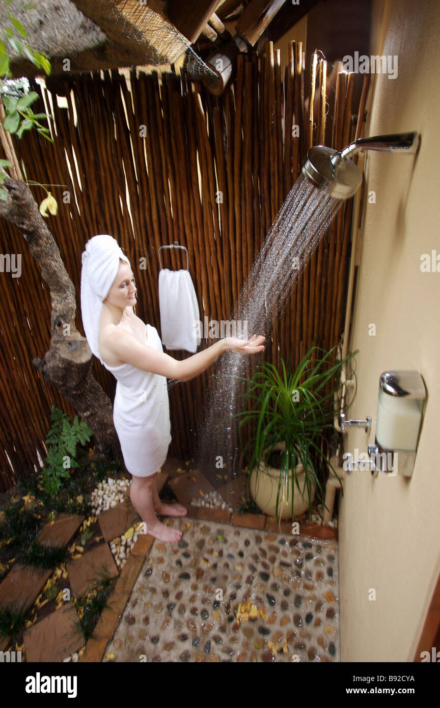 Lady Testing Her Shower Water In A Safari Lodge Outdoor Shower Sabi