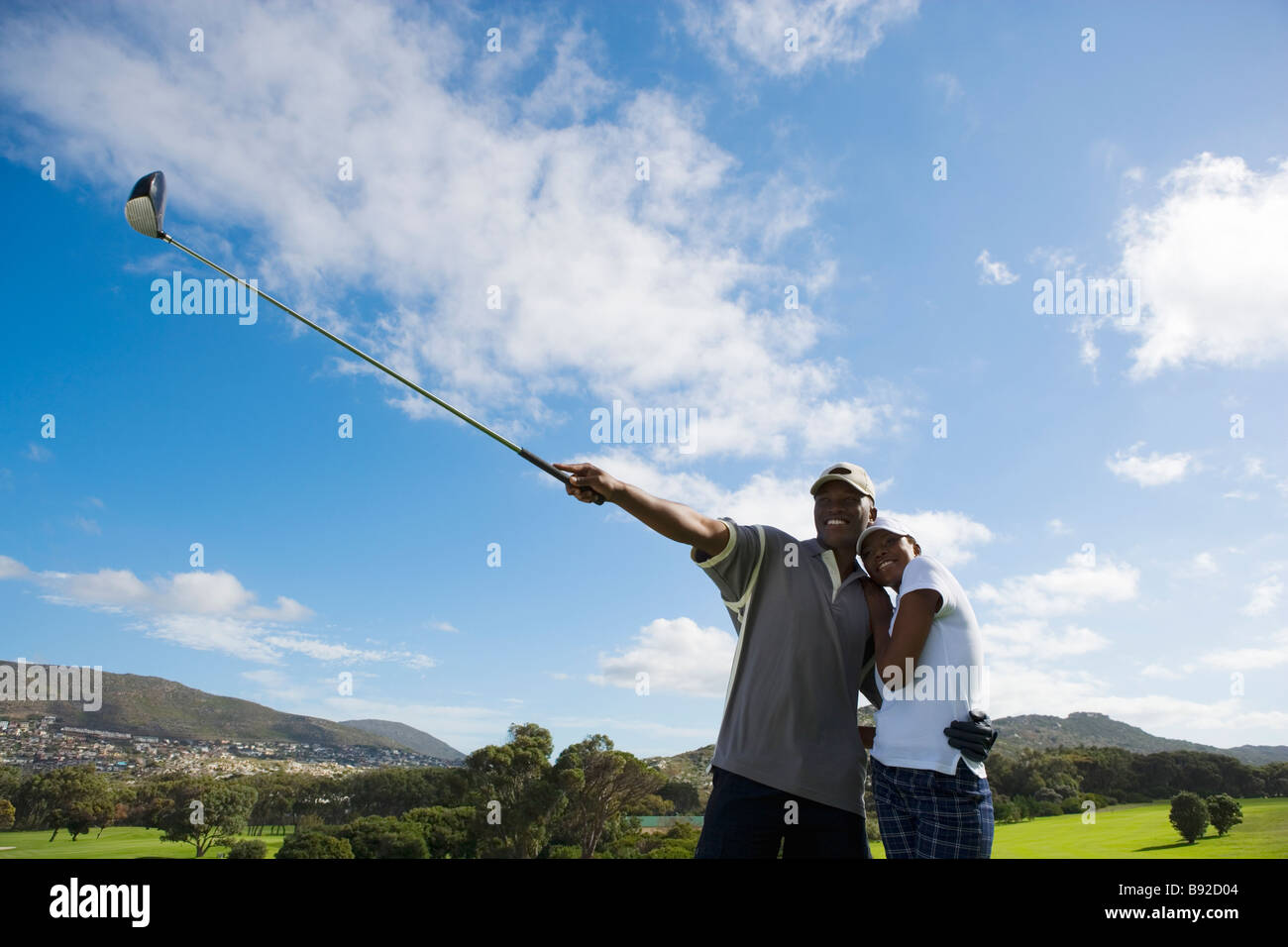 Front View of Man pointing Golf Club Skywards Stock Photo