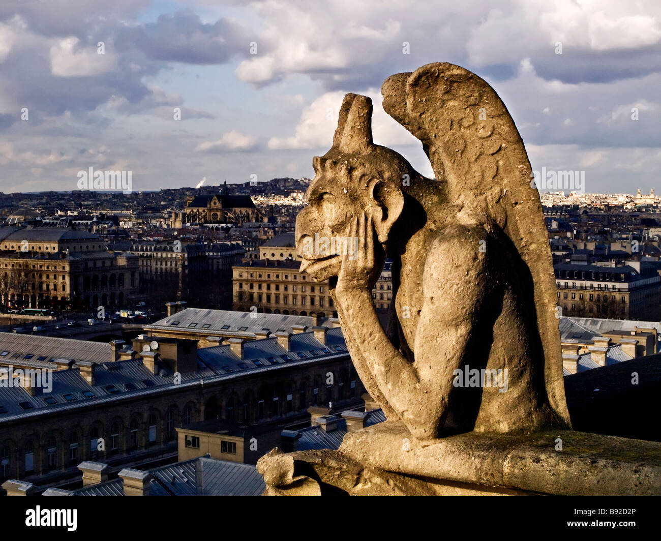 Gargoyle overlooking Paris from a tower on the Cathedral of Notre Dame