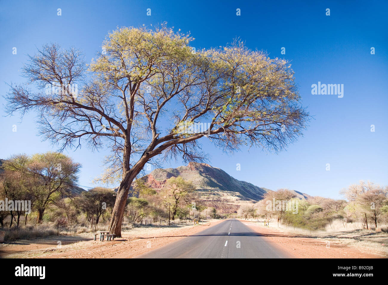 The road leading in to Thabazimbi The mountain in the foreground is being mined for iron Thabazimbi Northern Province South Afri Stock Photo