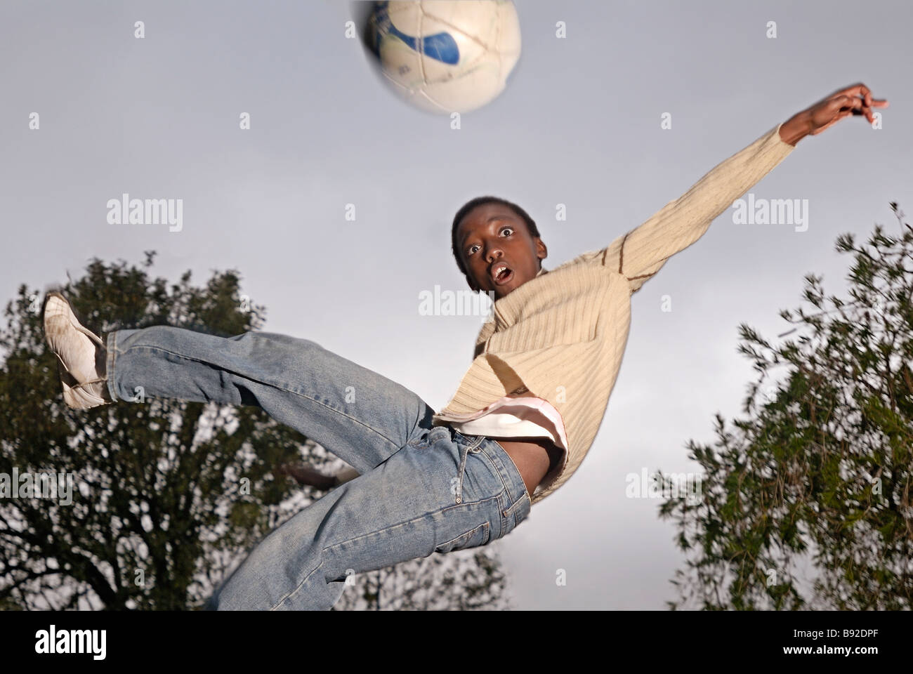 Young boy leaping for soccer ball Cape Town Rosebank Western Cape Province South Africa Stock Photo