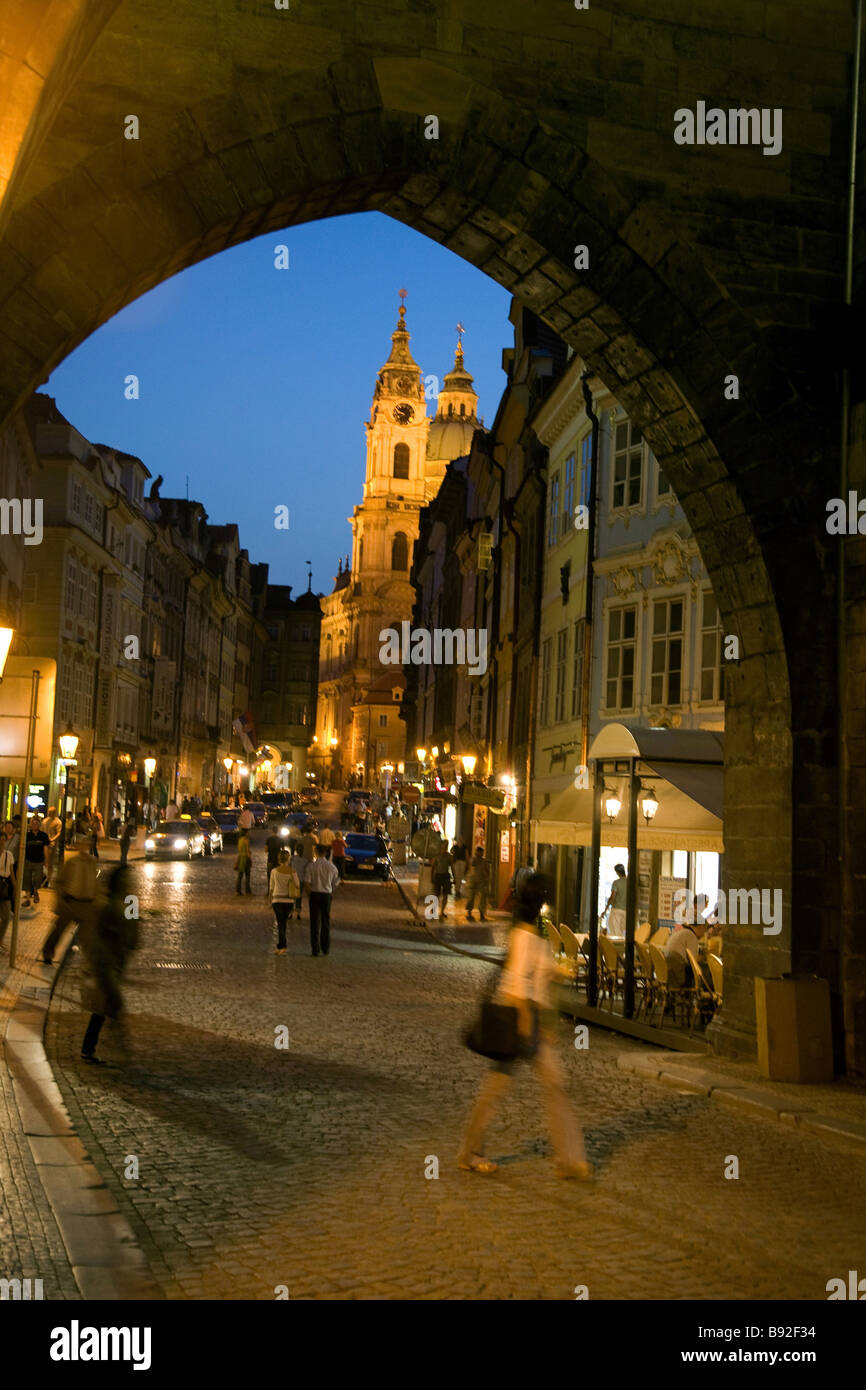 People wandering the cobbled streets of Mala Strana at night Prague Czech Republic Stock Photo