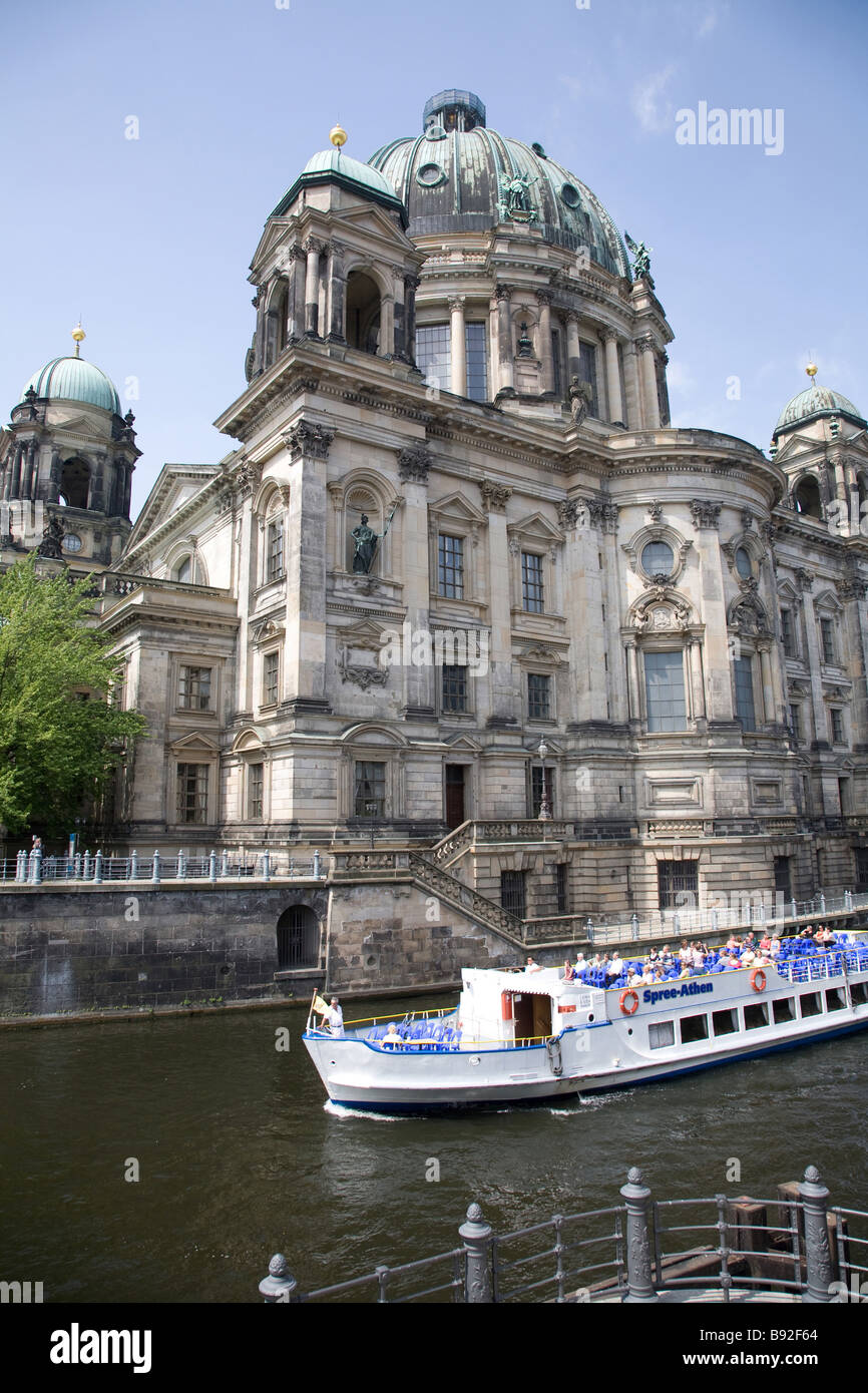The Berlin Cathedral Berliner Dom with a tourist boat passing by Berlin Germany Stock Photo