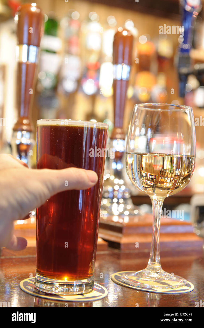 man s hand taking a pint of beer from bar Stock Photo