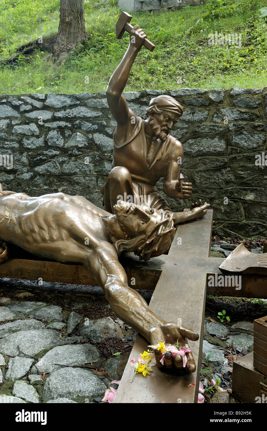 Jesus is nailed to the cross from the stations of the cross Stock Photo