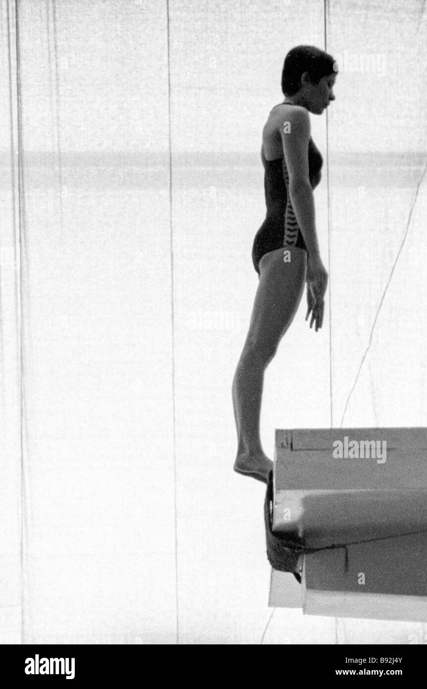 Olympic diving champion Yelena Vaitsekhovskaya standing on a diving platform during training