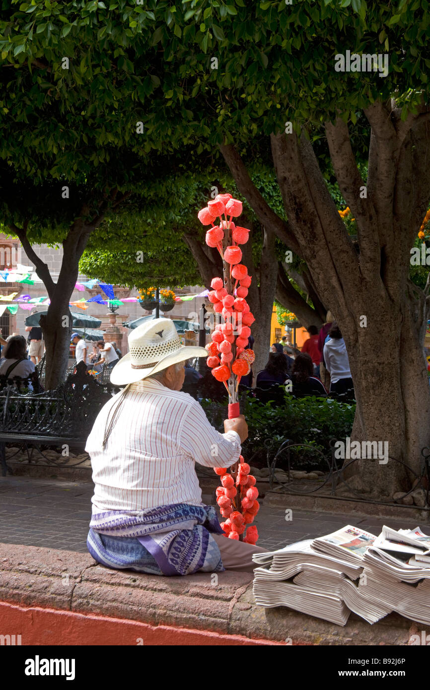 Selling Candied Apples and Newspapers at the Day of the Dead Celebration, San Miguel de Allende, Mexico Stock Photo